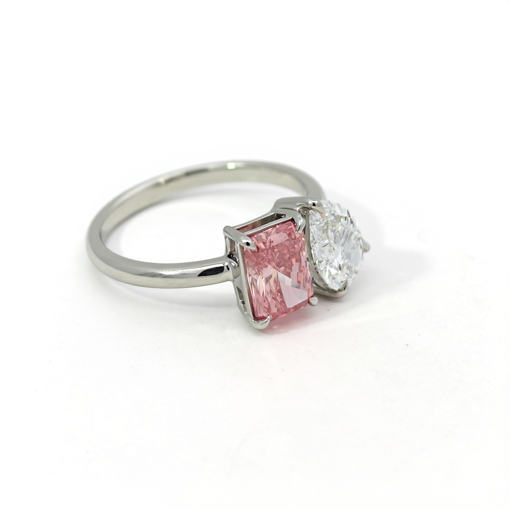 Angled view of 47AU Toi et Moi ring featuring 1.06 ct radiant fancy vivid pink and 1.05 ct pear white lab-grown diamonds in Platinum 950