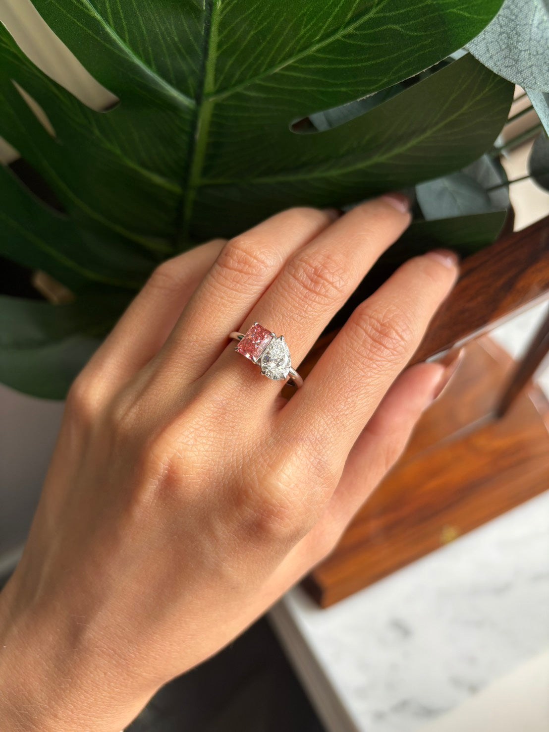 Model wearing 47AU Toi et Moi ring with radiant fancy vivid pink and pear white lab-grown diamonds in Platinum 950