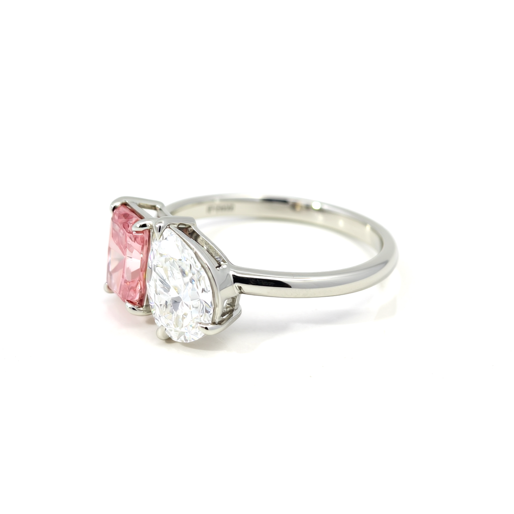 Side profile of 47AU Platinum 950 Toi et Moi ring with radiant fancy vivid pink and pear white lab-grown diamonds