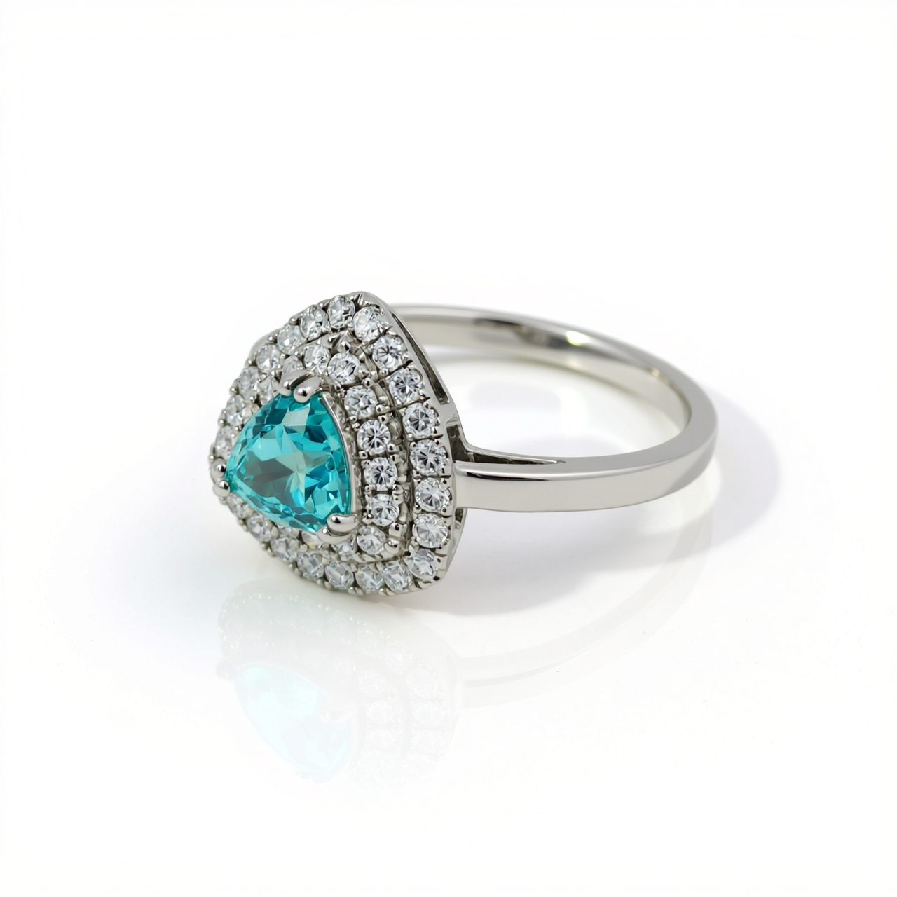 Side profile of 47AU trilliant Paraiba tourmaline imitation ring in 10K white gold showing raised setting and diamond halo
